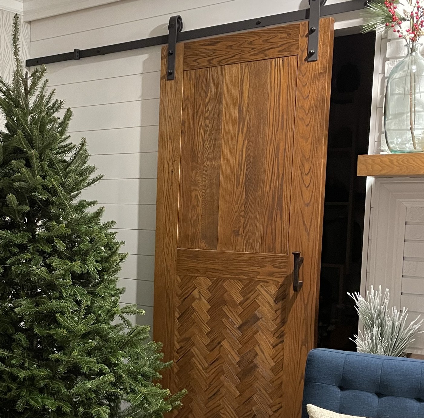 Barn door built by J Drake Customs against white shiplap